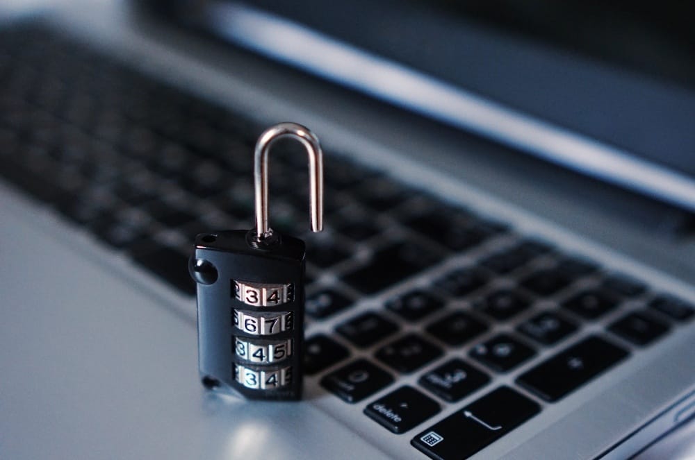 A laptop with an open 4 digit code lock place on it
